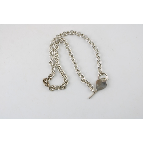 573 - A silver Tiffany style necklace in sterling silver with T bar and heart shaped charm. Length 46.5cm.... 