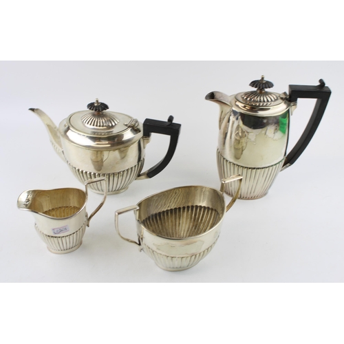 574 - A collection of silver plated items to include a coffee pot, tea pot cream and sugar. Height 19.5cm.