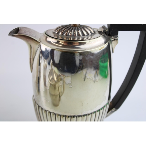 574 - A collection of silver plated items to include a coffee pot, tea pot cream and sugar. Height 19.5cm.