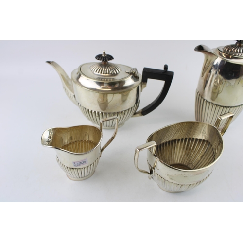 574 - A collection of silver plated items to include a coffee pot, tea pot cream and sugar. Height 19.5cm.