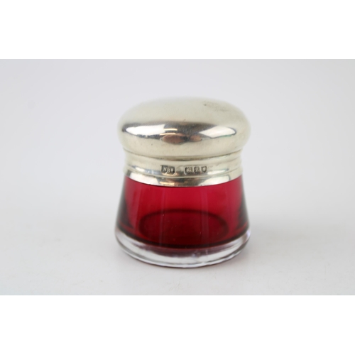 576 - Silver topped cranberry glass pot, 43mm, London 1910, 'N Bs'.