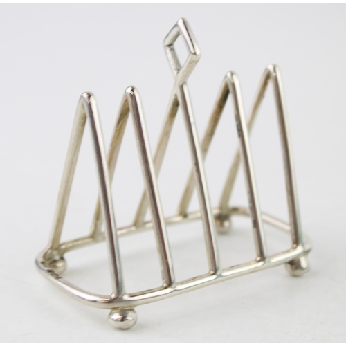 587 - Silver five bar miniature toast rack, Sheffield 1914, C W Fletcher, 47.5g, 7cm wide.