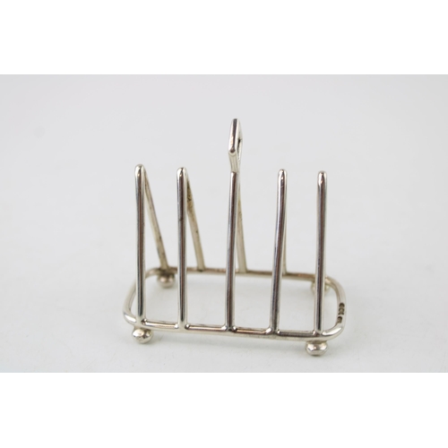 587 - Silver five bar miniature toast rack, Sheffield 1914, C W Fletcher, 47.5g, 7cm wide.