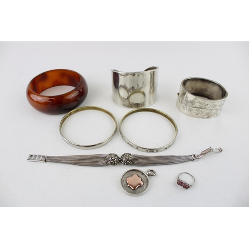 619 - A group of silver jewellery comprising a cuff bangle, marked 925, a Mexican silver bangle engraved w... 