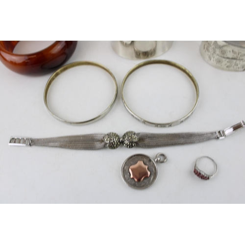 619 - A group of silver jewellery comprising a cuff bangle, marked 925, a Mexican silver bangle engraved w... 