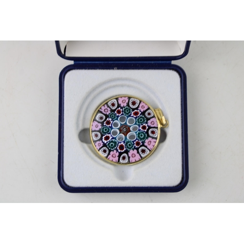 629 - Millefiori glass pendant in yellow coloured metal mount. Diameter 33mm.