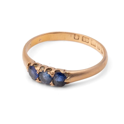 418 - A 22ct gold and sapphire three stone ring, the three sapphires of similar size, approximately 3.7mm,... 