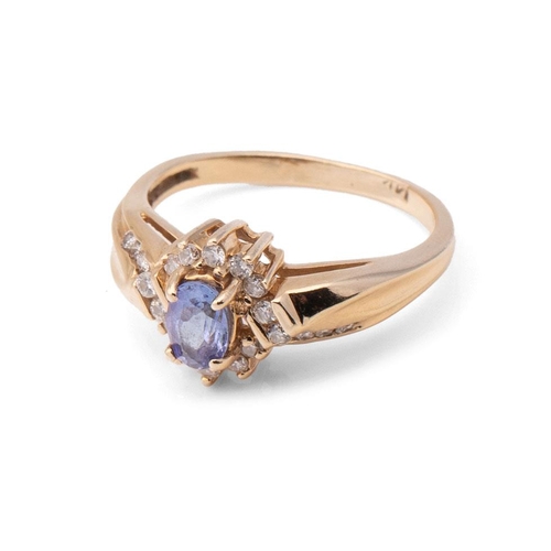 421 - A 14ct gold, tanzanite and diamond set dress ring, the central oval cut tanzanite of approximately 4... 