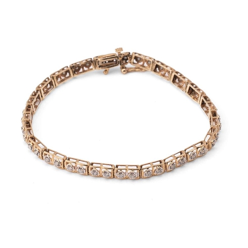 423 - A 10ct gold and diamond tennis bracelet, of twenty two panels each set with two diamonds, 6.4g, 18cm... 