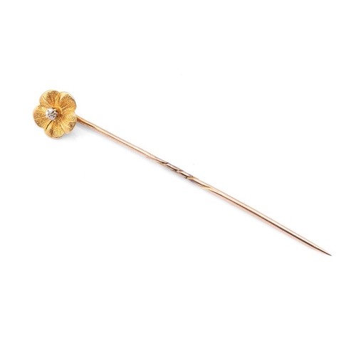 443 - 18ct gold flower head stick pin, diamond chip to centre, 9ct gold pin, 67mm long.