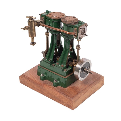 69 - A Stuart Turner stationary two piston marine engine mounted on a wooden plinth. Height 17.5cm.