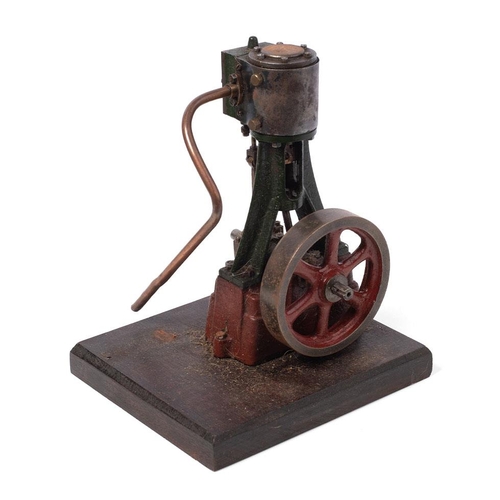 70 - A Stuart Turner vertical stationary steam engine mounted on a wooden plinth. Height 22cm.