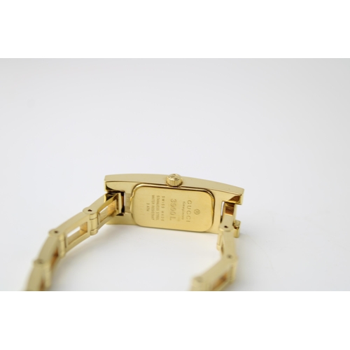 266 - A lady's Gucci wristwatch, signed black dial, back case marked Gucci 3900L, 038821, with gold colour... 