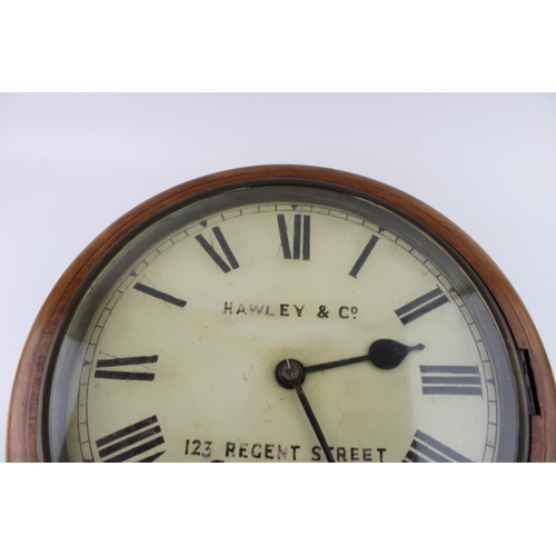 35 - An oak cased wall clock / school clock. Brass bezel with white dial and Roman numerals, HAWLEY & Co.... 