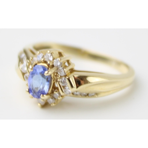 421 - A 14ct gold, tanzanite and diamond set dress ring, the central oval cut tanzanite of approximately 4... 