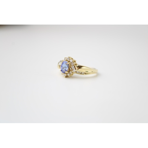 421 - A 14ct gold, tanzanite and diamond set dress ring, the central oval cut tanzanite of approximately 4... 