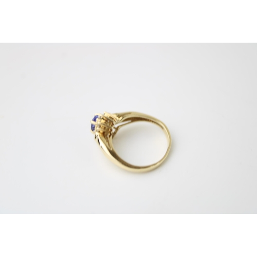 421 - A 14ct gold, tanzanite and diamond set dress ring, the central oval cut tanzanite of approximately 4... 