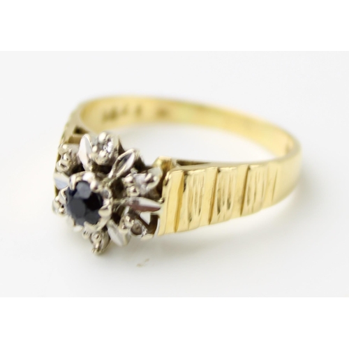 422 - An 18ct gold, sapphire and diamond flowerhead ring, of brutalist design, circa 1971, the centreal sa... 