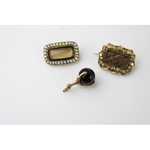 433 - A 19th century mourning brooch, set with seed pearls with black enamel border, another similar with ... 