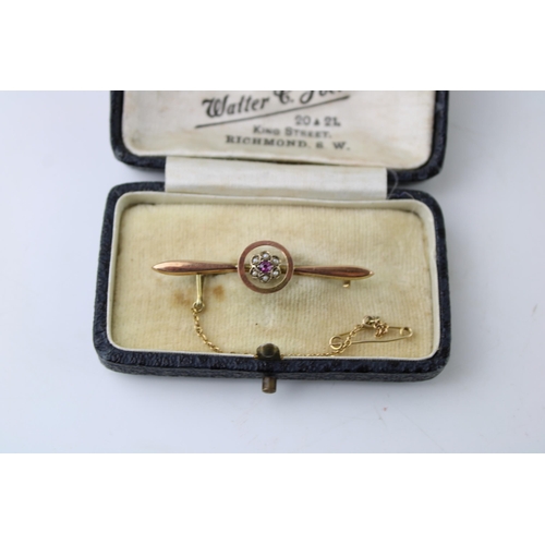 438 - A 9ct yellow gold bar brooch / stock pin set ruby and seed pearls with safety chain in period jewell... 