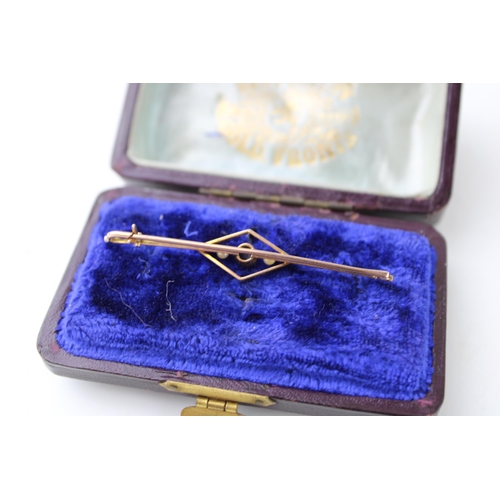 445 - A cased 14ct gold Art Deco style bar brooch set pearls and blue stone. Width 57mm. Weight 2.4g.