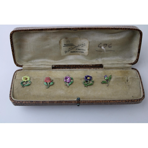 446 - A set of five silver button clips with enamelled decoration, floral design, in fitted case, 1 missin... 