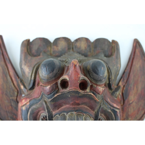 46 - An early 20th century Balinese hand carved Barong Mask. Height 21cm.