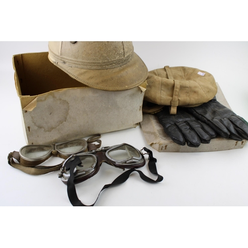 55 - An early 20th century flying / motoring hat, two pairs of goggles, a pair of leather gloves together... 