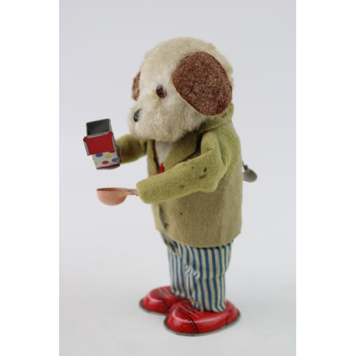 66 - Alps 'Greedy Pup' Japan clockwork tin toy, circa 1950's wearing a felt jacket with blue and white st... 