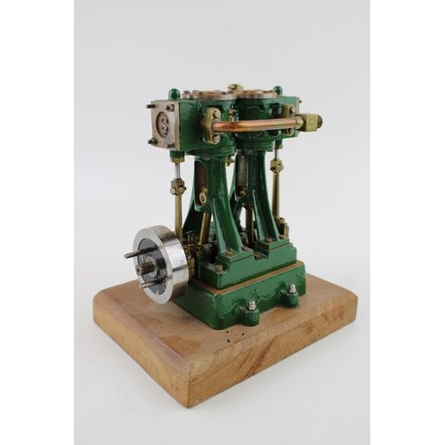 69 - A Stuart Turner stationary two piston marine engine mounted on a wooden plinth. Height 17.5cm.