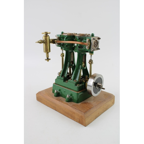 69 - A Stuart Turner stationary two piston marine engine mounted on a wooden plinth. Height 17.5cm.