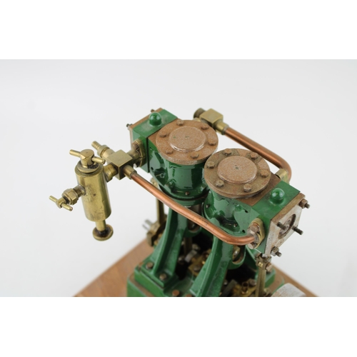 69 - A Stuart Turner stationary two piston marine engine mounted on a wooden plinth. Height 17.5cm.