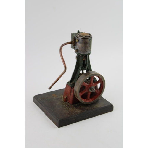 70 - A Stuart Turner vertical stationary steam engine mounted on a wooden plinth. Height 22cm.