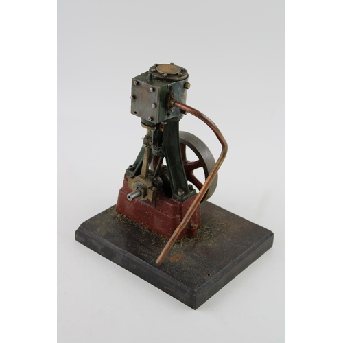 70 - A Stuart Turner vertical stationary steam engine mounted on a wooden plinth. Height 22cm.