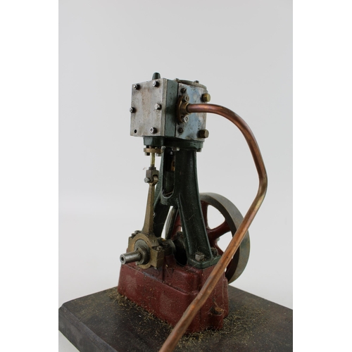 70 - A Stuart Turner vertical stationary steam engine mounted on a wooden plinth. Height 22cm.