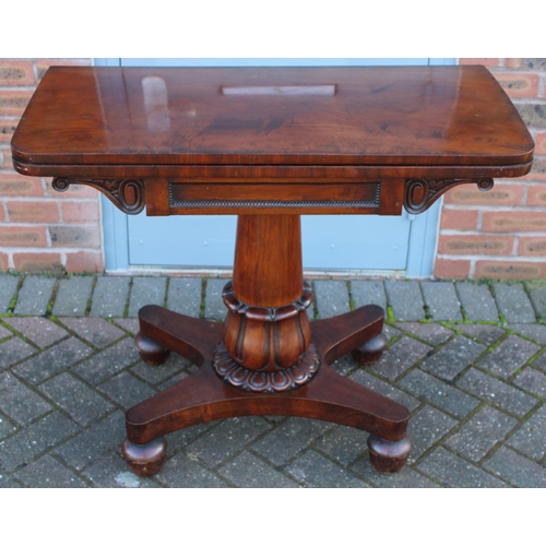 33A - William IV / early Victorian mahogany games table, carved tapered column, raised on four acorn feet,... 