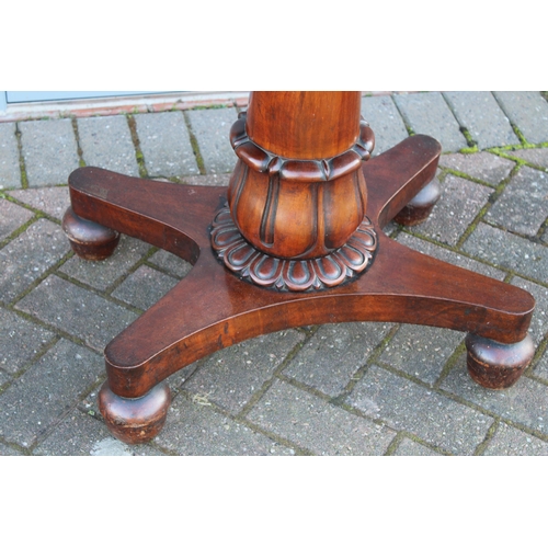 33A - William IV / early Victorian mahogany games table, carved tapered column, raised on four acorn feet,... 