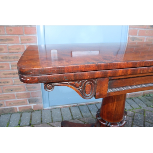 33A - William IV / early Victorian mahogany games table, carved tapered column, raised on four acorn feet,... 