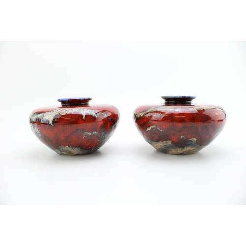 123 - A pair of Black Ryden squashed bulbous vases, signed by Anita Harris, dated 2002, 15cm diameter (2).
