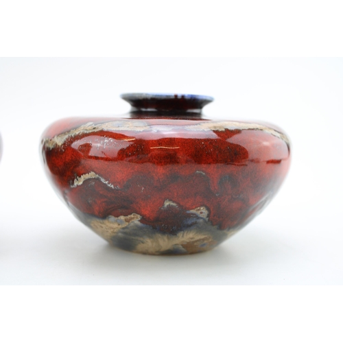 123 - A pair of Black Ryden squashed bulbous vases, signed by Anita Harris, dated 2002, 15cm diameter (2).