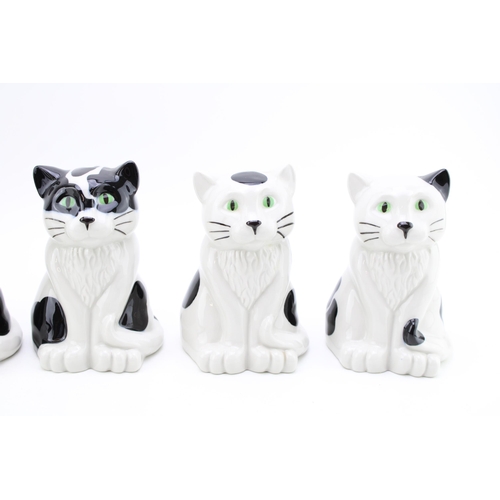 143 - A collection of Wade cat money boxes in five different designs. Height 16.5cm. (5)