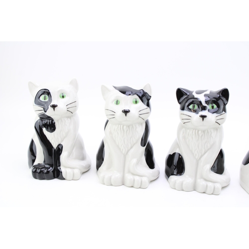 143 - A collection of Wade cat money boxes in five different designs. Height 16.5cm. (5)