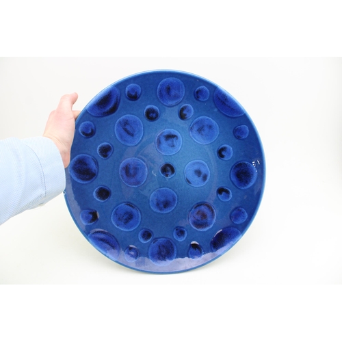 156 - Large Poole Pottery charger decorated with blue spots on blue background, 40cm diameter.