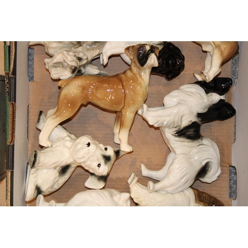 167 - A large collection of ceramic dogs to include examples by The Leonardo Collection, Coopercraft, and ... 