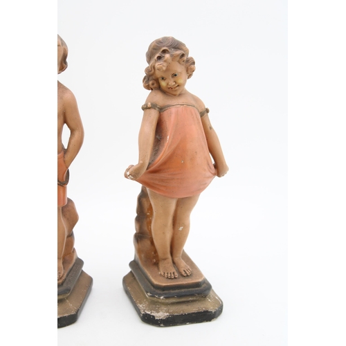 171 - A pair of continental Art Deco chalk ware figures in the form of a boy and a girl. Height 32cm.