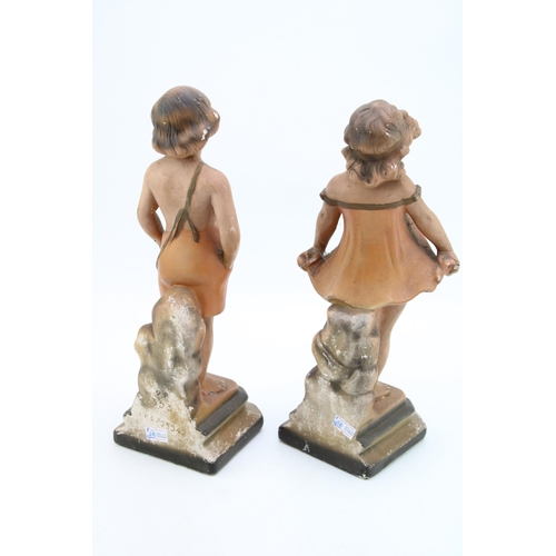 171 - A pair of continental Art Deco chalk ware figures in the form of a boy and a girl. Height 32cm.