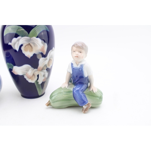 195 - Royal Copenhagen to include a boy seated on a marrow, a floral vase 1886 and a small bulbous vase 23... 