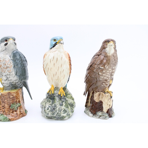 21 - Four Royal Doulton bird whisky decanters to include  a Barn Owl, a Kestrel, a Buzzard and a Peregrin... 