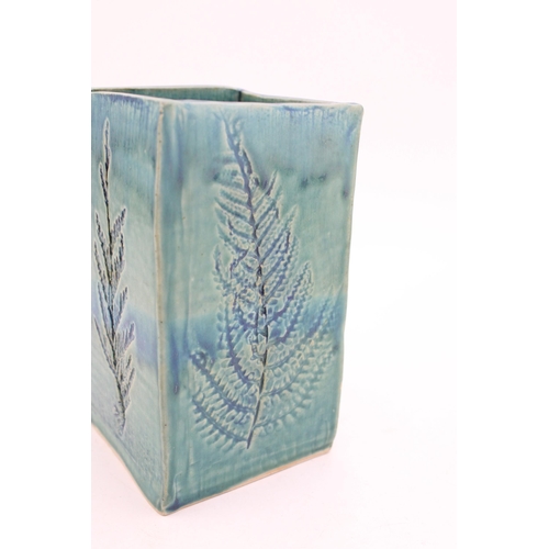 212 - A studio pottery 'Old Fern' type vase in blue / green glaze. Sticker to base, F / P. Height 16.5cm.