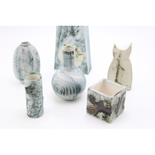 217 - A collection of Carn Pottery items to include fish and cat vases signed John Beusman, together with ... 